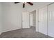 A bright, cozy bedroom features neutral carpet, gray walls, and a ceiling fan for added comfort at 2705 S Danube Way # 110, Aurora, CO 80013