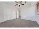 Bedroom featuring neutral walls, carpet, ceiling fan, and multiple access doors at 2705 S Danube Way # 110, Aurora, CO 80013