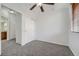 Bedroom featuring neutral walls, carpet, ceiling fan, closet, and ensuite bathroom at 2705 S Danube Way # 110, Aurora, CO 80013