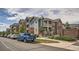 Attractive condo building featuring balconies, a mix of siding, brick exterior, and well-maintained landscaping at 2705 S Danube Way # 110, Aurora, CO 80013