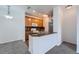 Open kitchen featuring wood cabinets, stone countertops, a breakfast bar, and modern appliances at 2705 S Danube Way # 110, Aurora, CO 80013