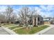 Large modern home with a tree in the front yard and driveway at 760 Jersey St, Denver, CO 80220