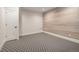 Spacious basement room with carpeted floor and wood-look accent wall at 760 Jersey St, Denver, CO 80220