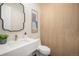 Stylish powder room with modern vanity and wood-paneled walls at 760 Jersey St, Denver, CO 80220