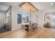 Elegant dining room with hardwood floors and a modern light fixture at 760 Jersey St, Denver, CO 80220