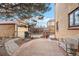 View of back patio with textured concrete, bench and detached garage at 2646 Colorado Blvd, Denver, CO 80207
