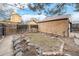 View of backyard, small grassy area with stone borders, garage and fencing at 2646 Colorado Blvd, Denver, CO 80207