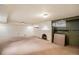 Spacious basement area featuring a fireplace, offering potential for various uses at 2646 Colorado Blvd, Denver, CO 80207