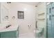 Modern bathroom with a glass-enclosed shower, floating shelves, and stylish fixtures at 2646 Colorado Blvd, Denver, CO 80207