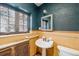 Blue bathroom featuring a pedestal sink, stained-glass window, and classic wall tiles at 2646 Colorado Blvd, Denver, CO 80207
