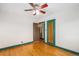 Bedroom with hardwood floors, a ceiling fan, and a classic doorway, creating an inviting space at 2646 Colorado Blvd, Denver, CO 80207