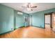 Cozy bedroom with hardwood floors, a ceiling fan, and a mini-split system for climate control at 2646 Colorado Blvd, Denver, CO 80207