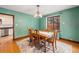 Dining room featuring hardwood floors, wainscotting, and large window at 2646 Colorado Blvd, Denver, CO 80207