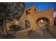 Home's exterior showcasing arched entry, stucco facade, and front yard at 2646 Colorado Blvd, Denver, CO 80207
