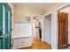 Entryway featuring hardwood floors, storage and views into the kitchen at 2646 Colorado Blvd, Denver, CO 80207