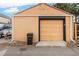 A view of the detached garage in the backyard with yellow door at 2646 Colorado Blvd, Denver, CO 80207