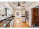 Galley kitchen with colorful tile counters, white cabinets and hardwood floors at 2646 Colorado Blvd, Denver, CO 80207