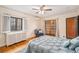 Comfortable main bedroom with hardwood floors, bright windows, and comfortable chair at 2646 Colorado Blvd, Denver, CO 80207