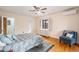 Comfortable bedroom with hardwood floors, ceiling fan, and bright window at 2646 Colorado Blvd, Denver, CO 80207