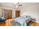 Spacious main bedroom features hardwood floors, ceiling fan, and access to a balcony at 2646 Colorado Blvd, Denver, CO 80207