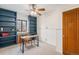 Well-lit office with built-in shelving, a ceiling fan, and a classic wooden door at 2646 Colorado Blvd, Denver, CO 80207