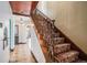 Elegant staircase with ornate iron railing and patterned carpet runner at 2646 Colorado Blvd, Denver, CO 80207