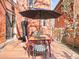 Outdoor dining area on wooden deck with an umbrella, surrounded by brick buildings, offering an inviting space at 1557 Fillmore St, Denver, CO 80206