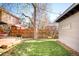 Spacious backyard featuring a well-maintained lawn, wooden fence, and a view of neighboring houses at 1557 Fillmore St, Denver, CO 80206