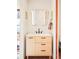 Stylish bathroom with a modern sink vanity, custom mirror, and sleek fixtures at 1557 Fillmore St, Denver, CO 80206