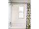 Bathroom showcasing a tub with white subway tile and floral shower curtain at 1557 Fillmore St, Denver, CO 80206