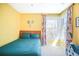 Bright bedroom with bay window, colorful curtains, and whimsical decor at 1557 Fillmore St, Denver, CO 80206