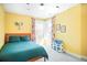 Bright bedroom featuring colorful walls, a large window, and stylish decor at 1557 Fillmore St, Denver, CO 80206