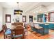 Open dining area with stylish lighting, hardwood floors, and breakfast bar to kitchen at 1557 Fillmore St, Denver, CO 80206