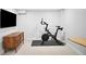 Exercise room featuring stationary bike, tv, and modern dresser at 1557 Fillmore St, Denver, CO 80206