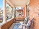 Inviting front porch features comfortable seating, a swing, and views of the neighborhood at 1557 Fillmore St, Denver, CO 80206
