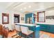 Modern kitchen with breakfast bar, stainless steel appliances, and custom cabinetry at 1557 Fillmore St, Denver, CO 80206