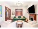 Warm living room with fireplace, plush seating, and natural light through leaded windows at 1557 Fillmore St, Denver, CO 80206