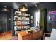 Home office with built-in bookshelves, custom desk, and contemporary lighting fixtures at 1557 Fillmore St, Denver, CO 80206