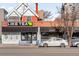 Street view of Like Tea and Pepper, businesses with eye-catching signage and a blue bench at 1557 Fillmore St, Denver, CO 80206