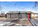 Modern home exterior with red door and paved patio at 1227 S Patton Ct, Denver, CO 80219