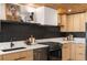 Modern kitchen with wood cabinets, stainless steel appliances and a unique backsplash at 1227 S Patton Ct, Denver, CO 80219