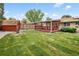 Backyard featuring a covered patio, a wooden shed, and a lawn at 5329 Flower Cir, Arvada, CO 80002