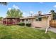 Backyard featuring a covered patio, solar panels, and a lawn at 5329 Flower Cir, Arvada, CO 80002