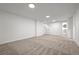 Spacious basement with neutral carpet, clean white walls, and ample room for activities at 5329 Flower Cir, Arvada, CO 80002