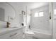 Elegant bathroom with marble tile, a gold-framed mirror, and modern fixtures at 5329 Flower Cir, Arvada, CO 80002