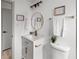 Chic bathroom with a white vanity, gold accents, and modern lighting fixtures at 5329 Flower Cir, Arvada, CO 80002