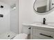 Modern bathroom featuring sleek fixtures, a walk-in shower, and a stylish vanity with marble countertop at 5329 Flower Cir, Arvada, CO 80002