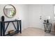 Bright entryway featuring light wood floors, modern decor, and a stylish round mirror at 5329 Flower Cir, Arvada, CO 80002