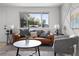 Stylish living room featuring a brown sofa, gray accent chair, and modern decor at 5329 Flower Cir, Arvada, CO 80002