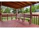 Covered wooden patio with wooden benches and views of the yard at 5329 Flower Cir, Arvada, CO 80002